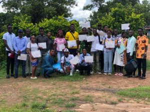 Group of teachers and volunteers holding certificates after completing environmental education training, Sierra Leone